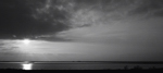 Salin de Giraud. Salines au coucher du soleil; &agrave; la gauche, le phare de Faraman &agrave; l`horizon.